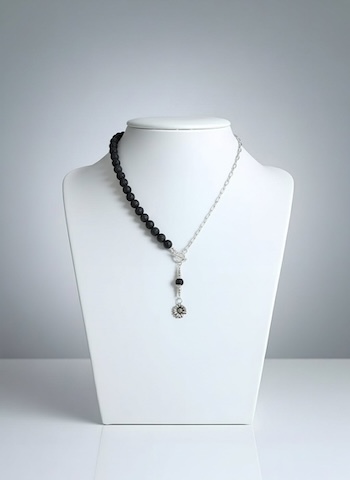 collier argent et roche volcanique